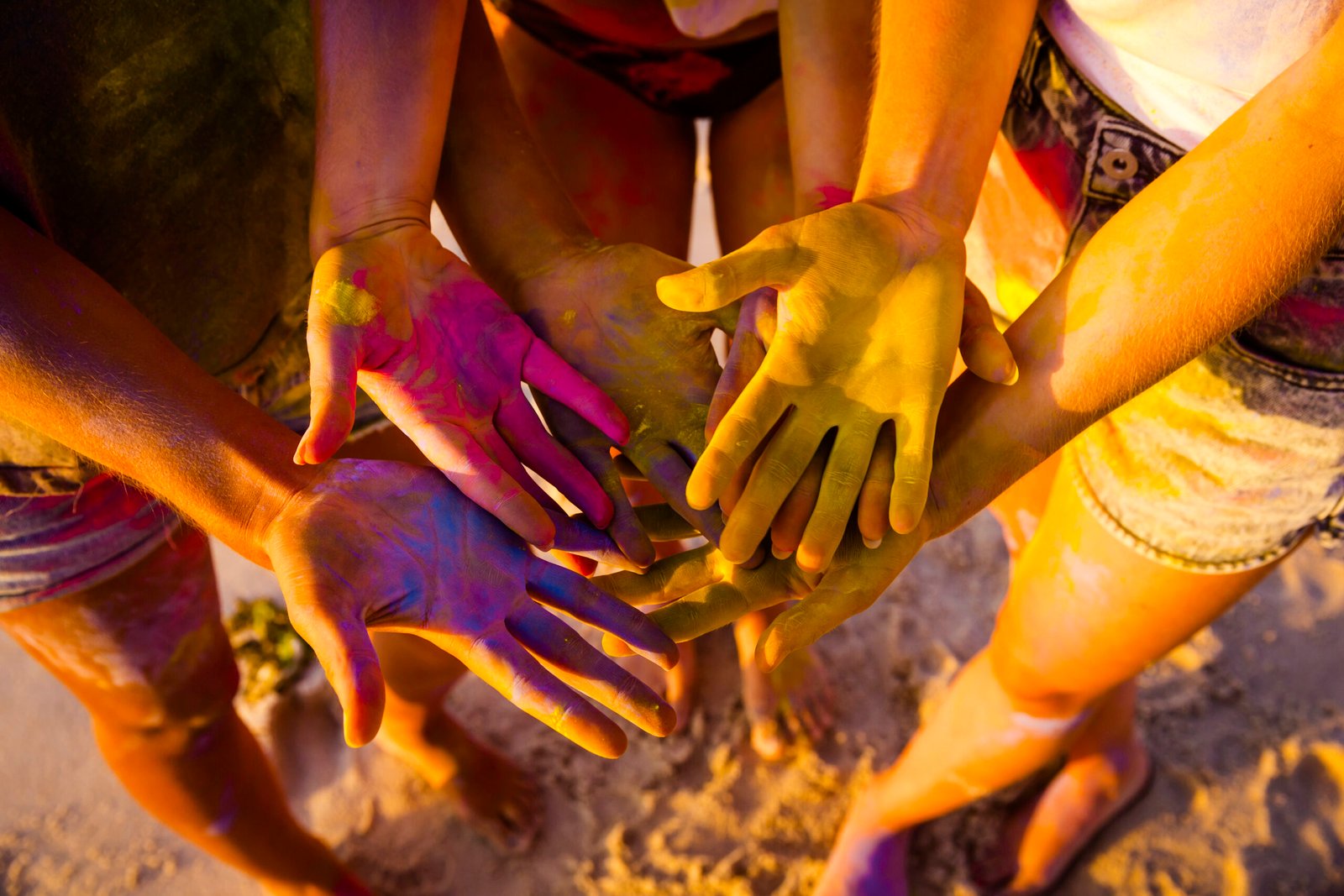 Teenagers playing with colored powder and showing her hands